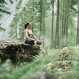 Image of woman forest bathing in a wooded area