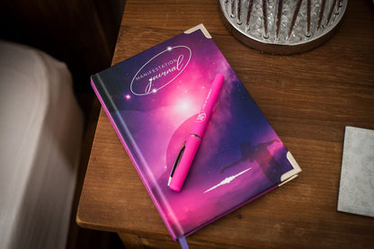 Manifestation Journal on a bedside table with pink pen